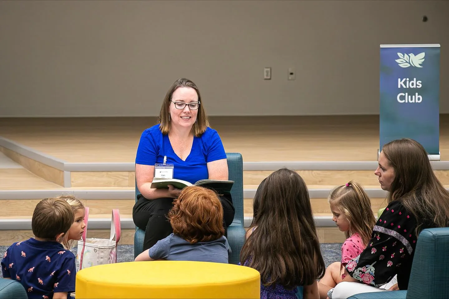 A Kids Club teacher leading a lesson with children