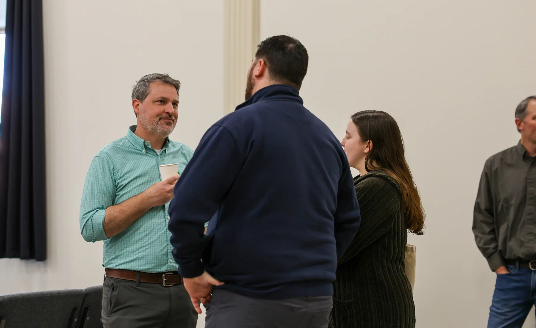 Men from the church catching up before worship